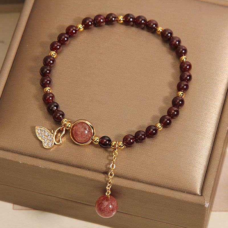 Garnet and butterfly bracelet charm close-up