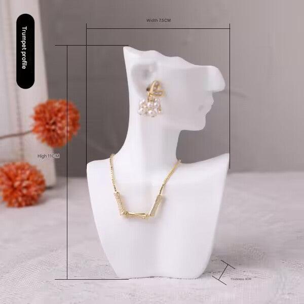 resin jewelry display stand in white storefront