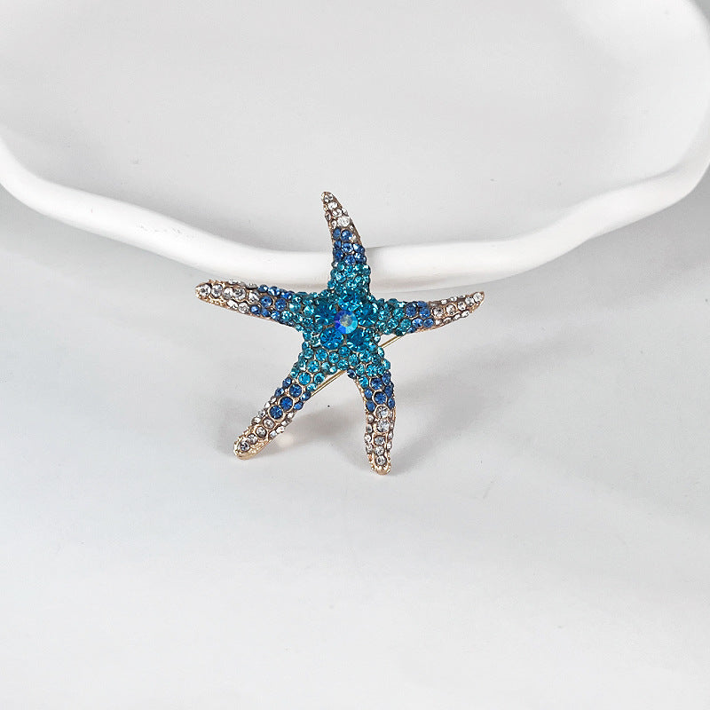 Rhinestone starfish brooch in blue