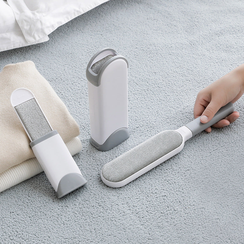 Double-sided pet hair remover brush displayed with pet hair