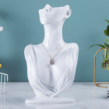 resin jewelry display stand in white storefront