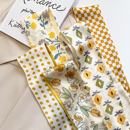 Yellow floral scarf tied to bag