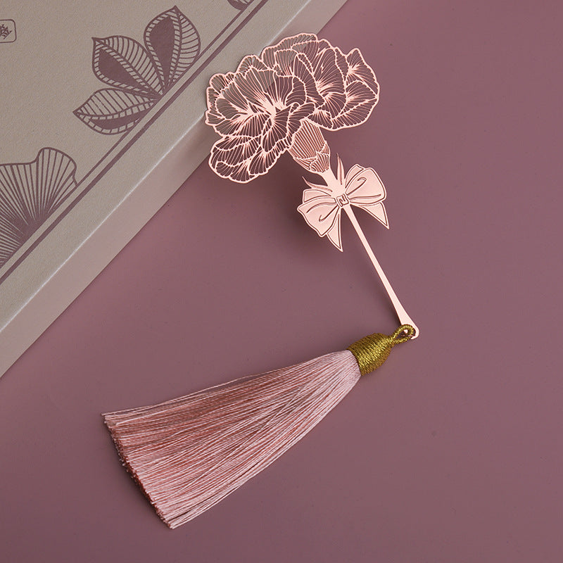 Elegant metal bookmark displayed on an open book