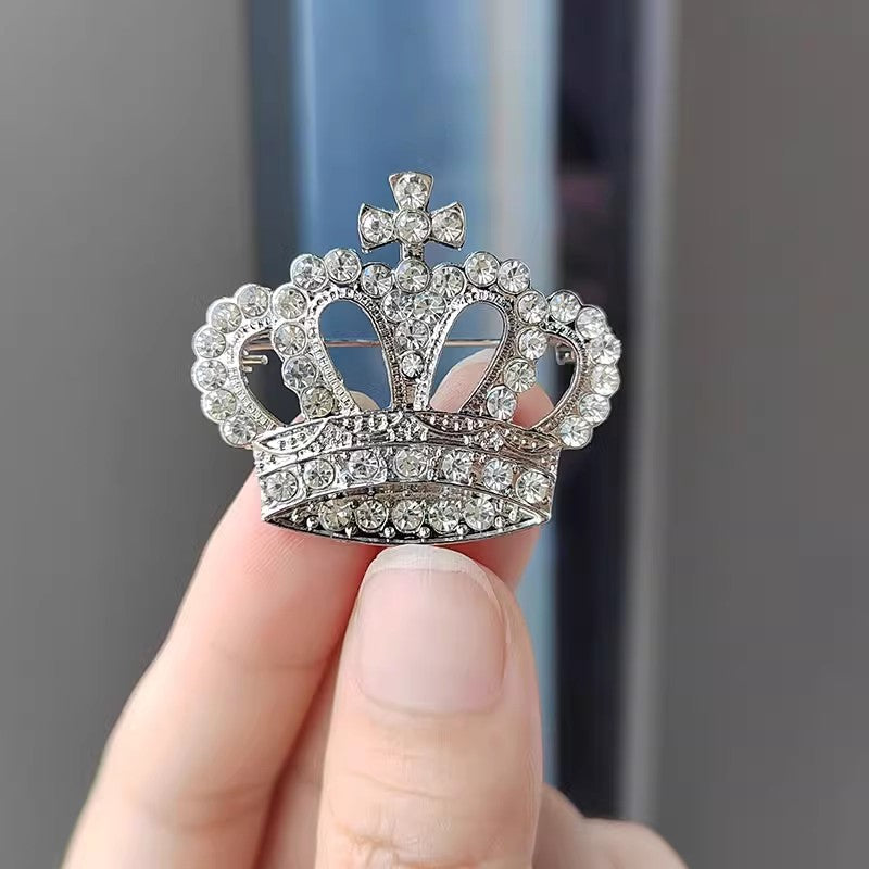 Detailed close-up of rhinestone crown pin