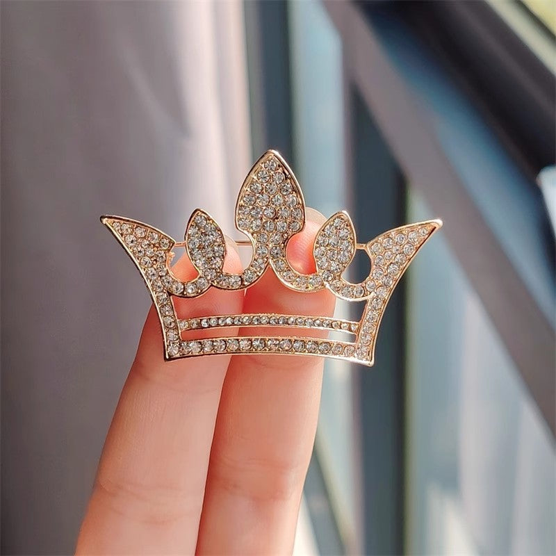 Couple's matching crown brooches