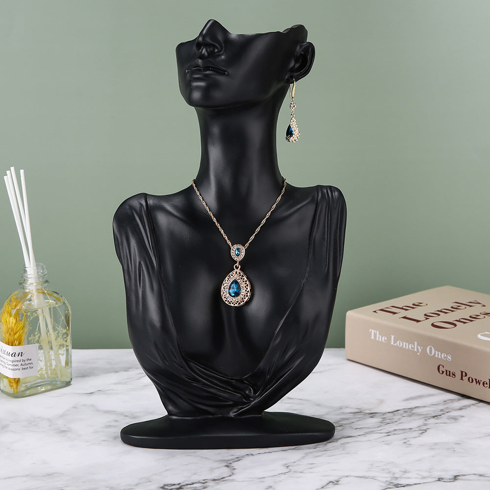 resin jewelry display stand in white storefront