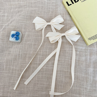 Blue bow hair clip styled on child's hair