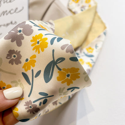 Yellow floral scarf tied to bag