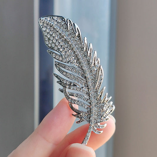 Elegant feather brooch on jacket