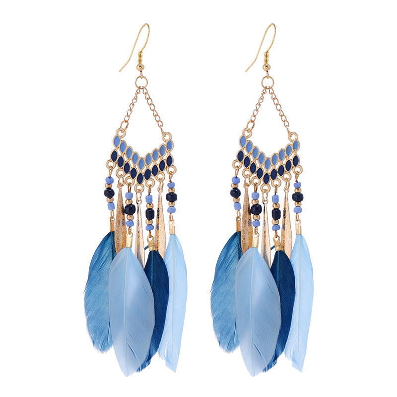 Closeup of blue feather tassel earrings