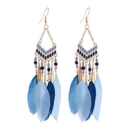 Closeup of blue feather tassel earrings