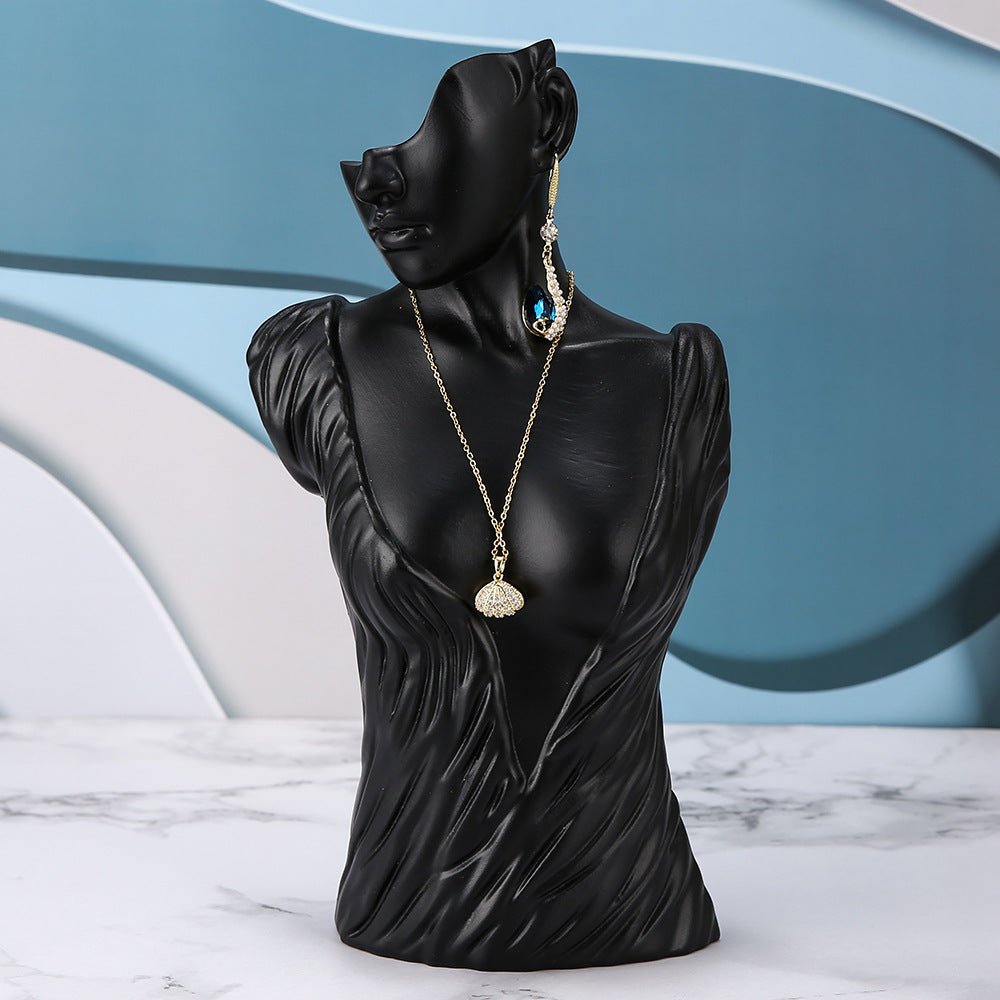 resin jewelry display stand in white storefront
